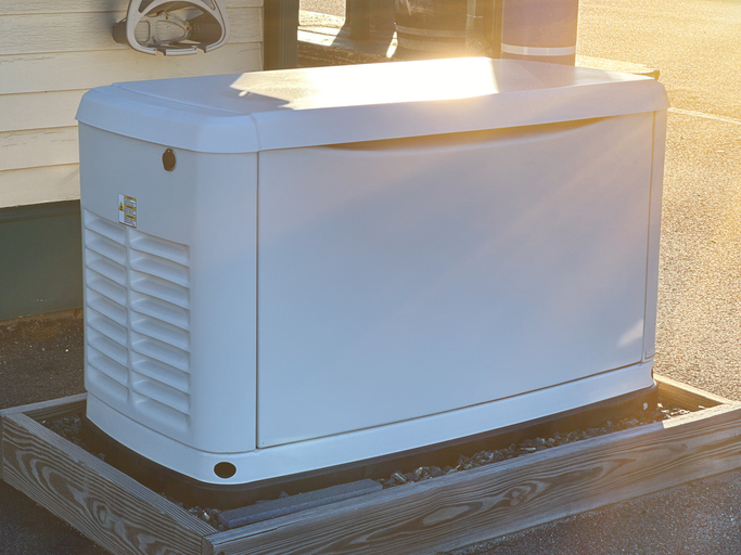 A Home Standby Generator installed at the backyard of a house.